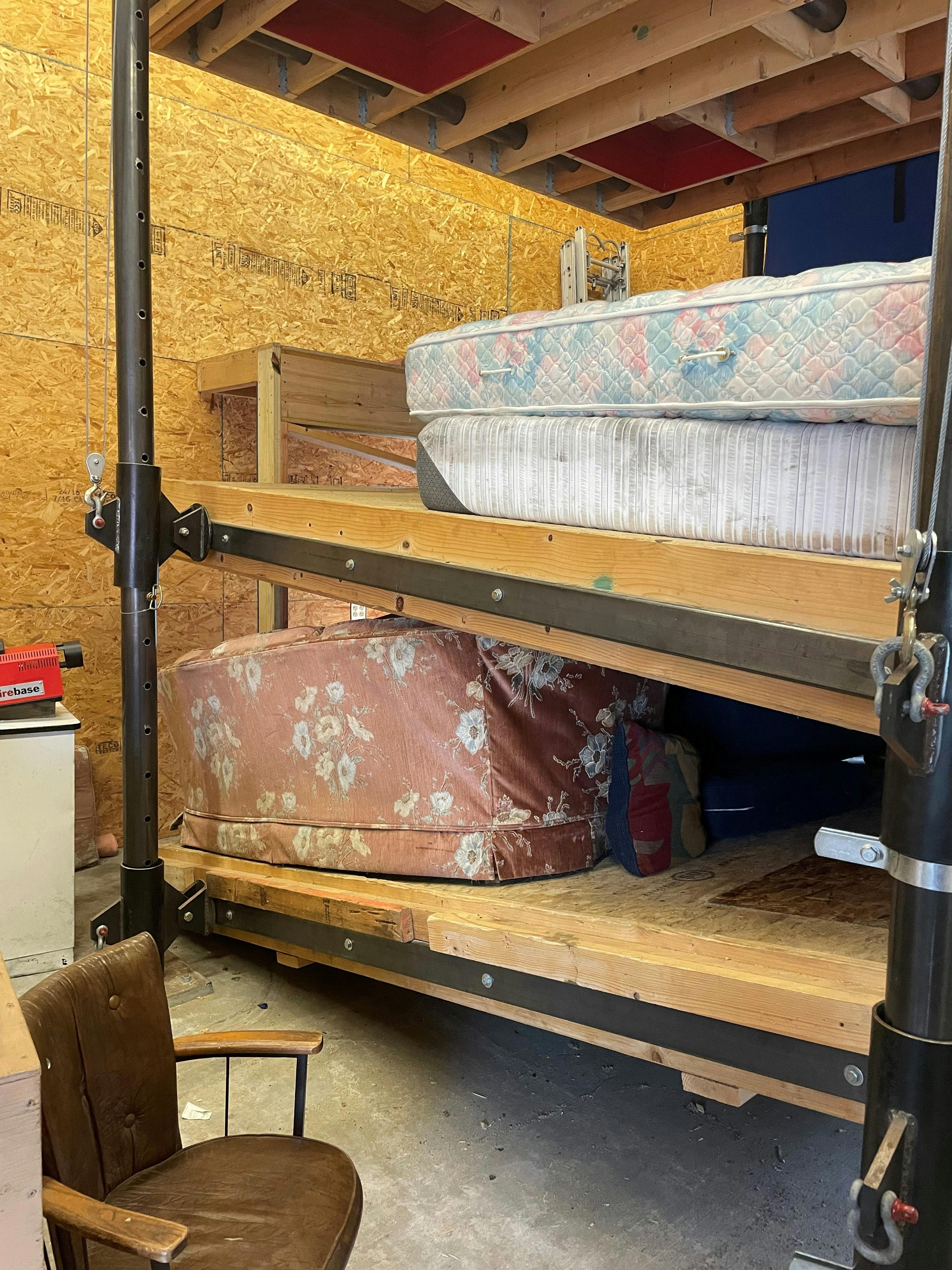 training prop of structural building collapse with upper floor slanted and resting on a manikin