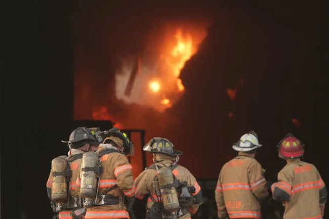 firefighters, officer and fire chief at structure fire