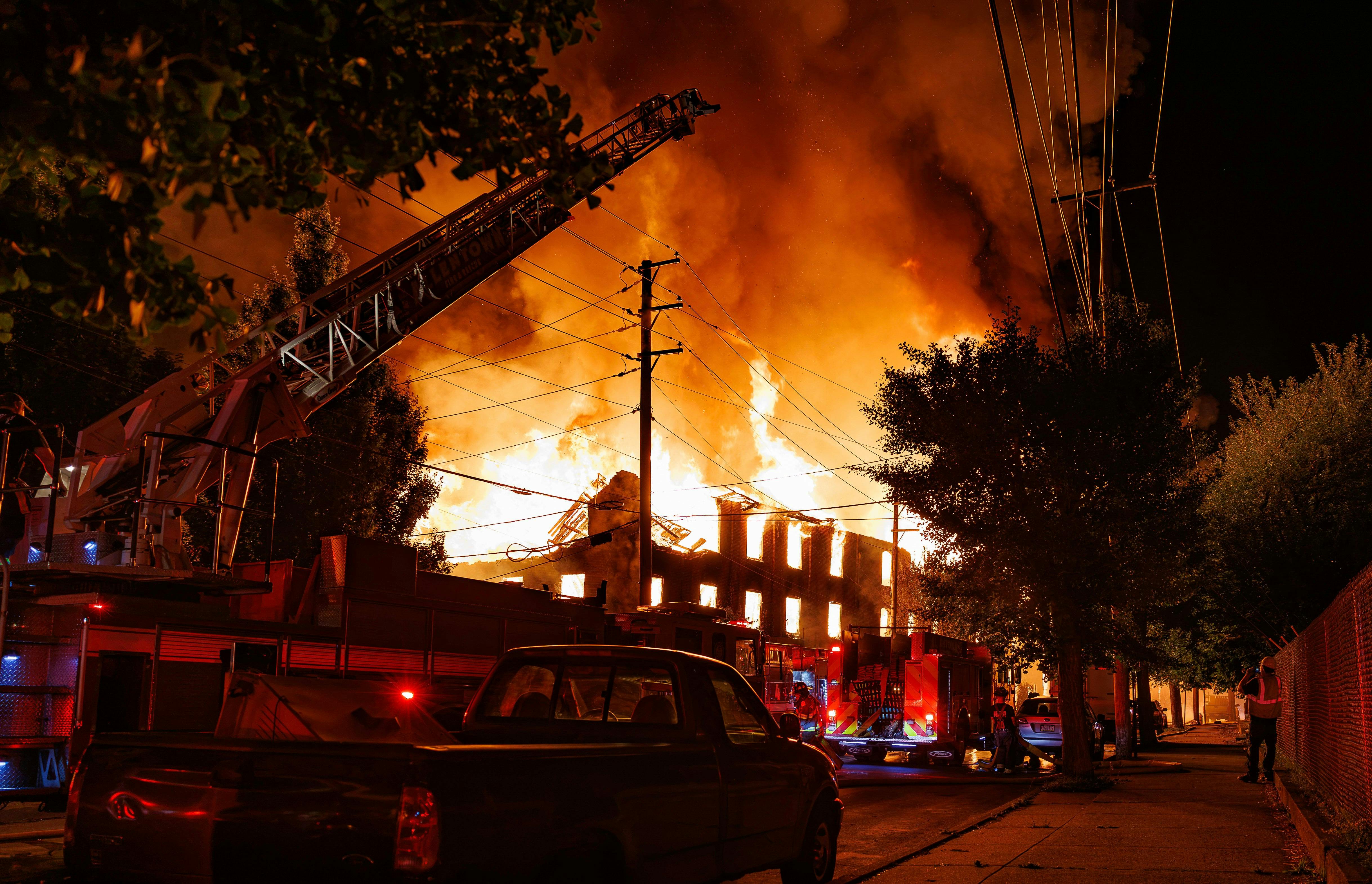 Two teens are being held in juvenile detention and face charges including arson, reckless endangerment, conspiracy and causing a catastrophe after a fire gutted a former furniture factory.