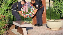 Frederick County Fire Rescue Recruits, David Courtney, left, and Zachary Lamb place a wreath at the Andew Waybright Memorial.