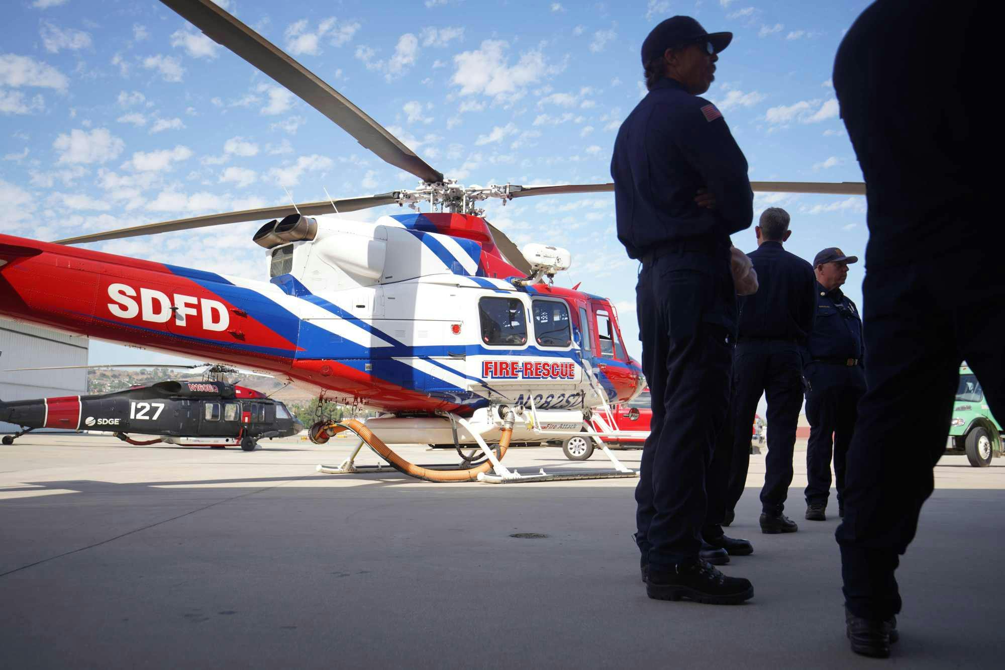 As layoffs loom for San Diego firefighters, a helicopter joined the search for the missing son of a retired fire chief.