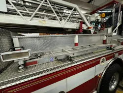 a cut-down section of the side of an aerial fire vehicle permits a small ground ladder to be stored there