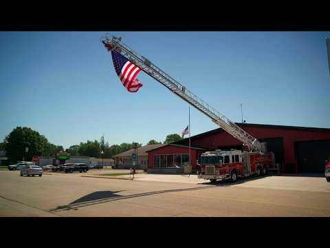 A flag flies outside Wabasha Fire Department in honor of two firefighters killed in a boat collision Saturday night.