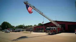 A flag flies outside Wabasha Fire Department in honor of two firefighters killed in a boat collision Saturday night.