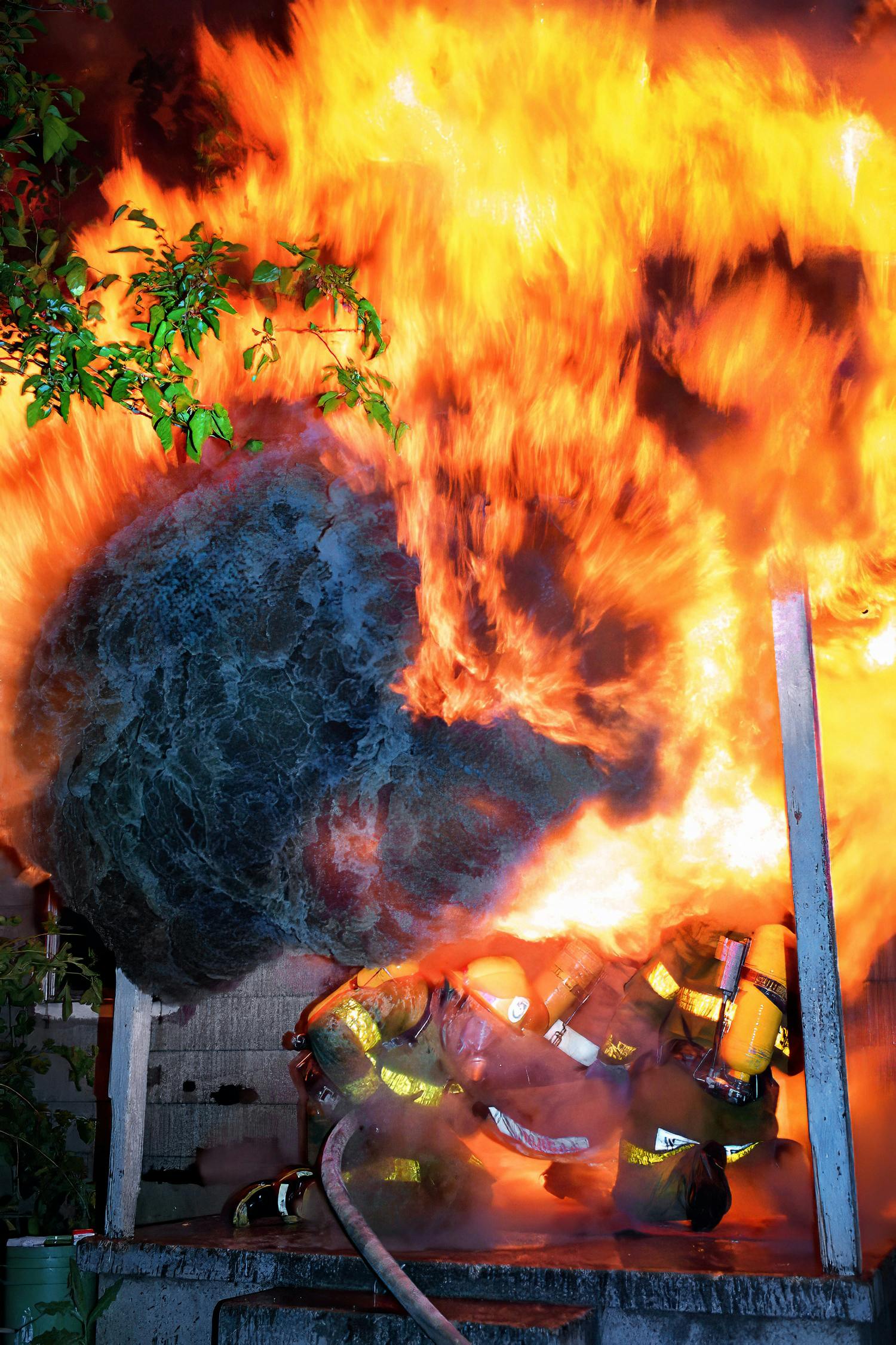 firefighters at front door of house as flashover occurs
