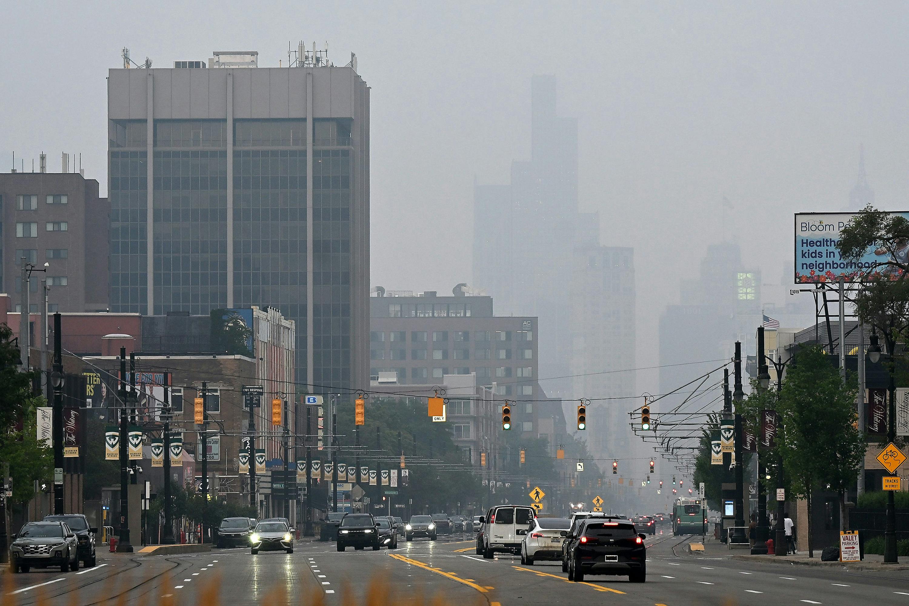 Haze from Canadian fires obscures the view of the skyline looking down Woodward Avenue in Detroit on July 15.