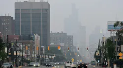 Haze from Canadian fires obscures the view of the skyline looking down Woodward Avenue in Detroit on July 15.