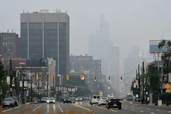 Haze from Canadian fires obscures the view of the skyline looking down Woodward Avenue in Detroit on July 15.