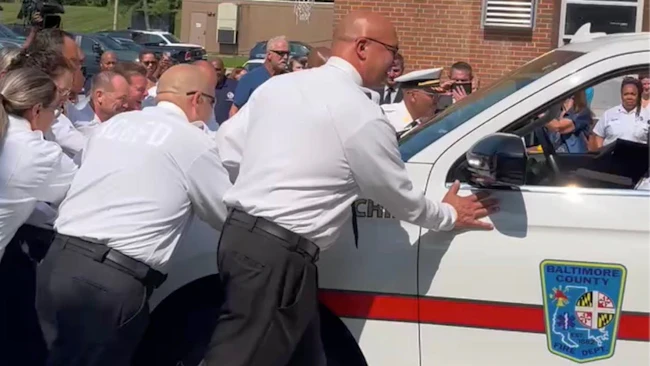 New Baltimore County battalion chiefs push a command vehicle into the Dundalk fire station.