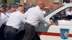 New Baltimore County battalion chiefs push a command vehicle into the Dundalk fire station.