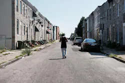 A man walks down a Baltimore street near where a person was murdered on July 28, 2019.
