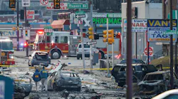 Charred debris littered the street following the crash of a medical jet that killed six people aboard and two on the ground.