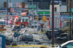 Charred debris littered the street following the crash of a medical jet that killed six people aboard and two on the ground.