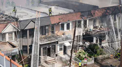 A 78-year-old woman died and 22 other people, including more than a dozen firefighters, were injured after a massive fire ripped through a Queens home on College Point Blvd. near 41st Rd. in Flushing, Queens on Saturday, July 25, 2026, before spreading to two adjoining buildings.