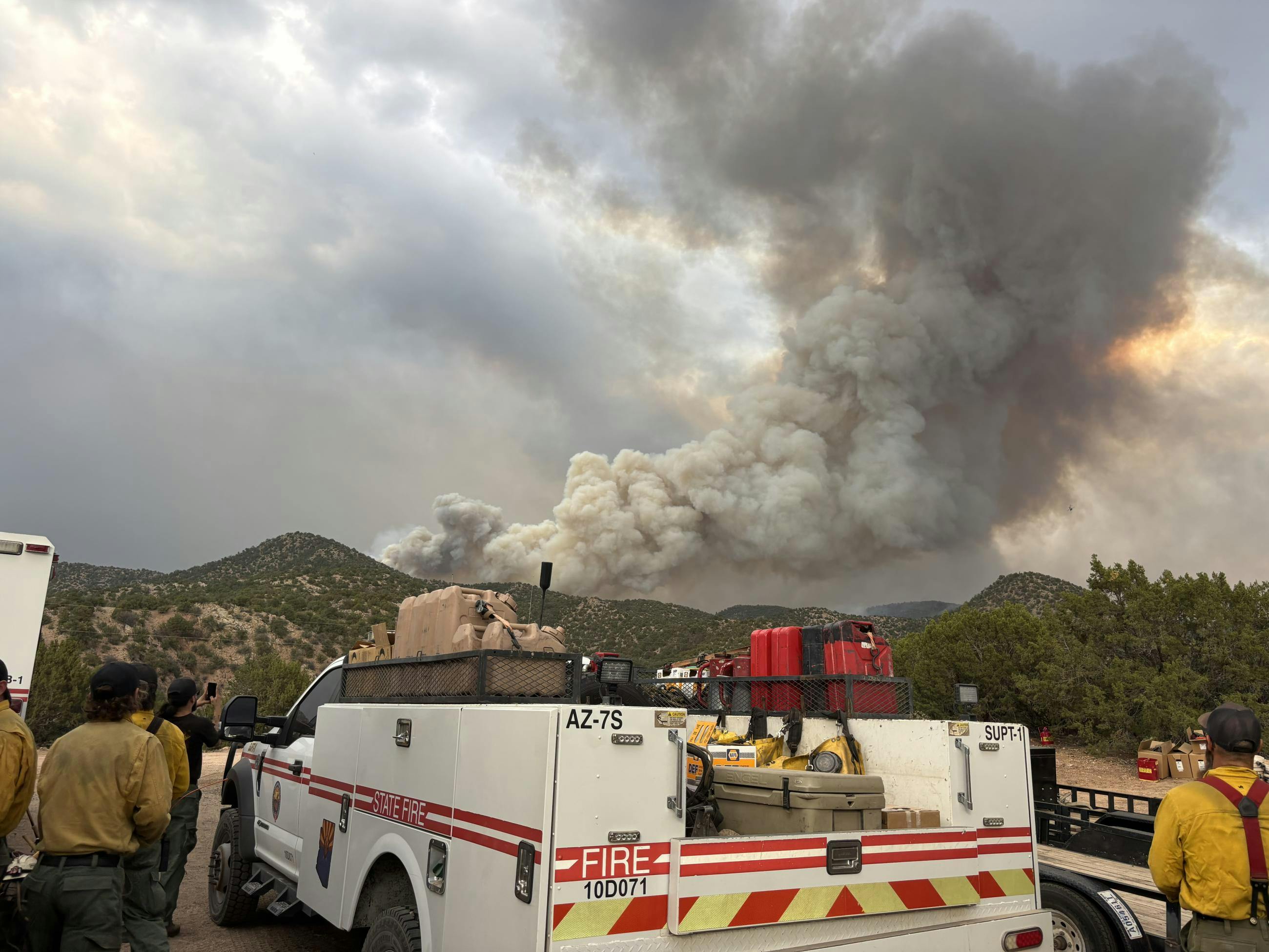 Firefighters involved in the Frijoles Fire near Santa Fe gather at a staging area.