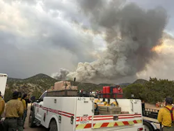 Firefighters involved in the Frijoles Fire near Santa Fe gather at a staging area.