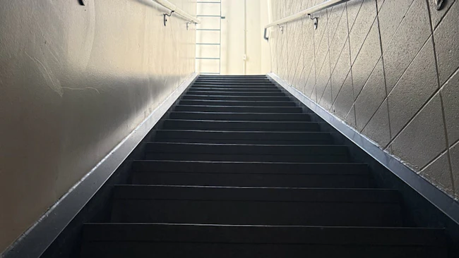 stairwell leading up as symbol of roadblock to promotion for many fire department middle managers