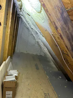 spray polyurethane foam that’s applied directly to the underside of a residential roof deck in a narrow attic space.