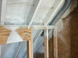 SPF applied beneath the roof sheathing between exposed framing members.