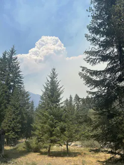 A smoke column rises from the northwest edge of the Little Giant Fire.