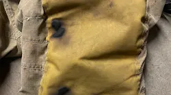 burned knee pads of firefighter who knelt on hot embers during a training