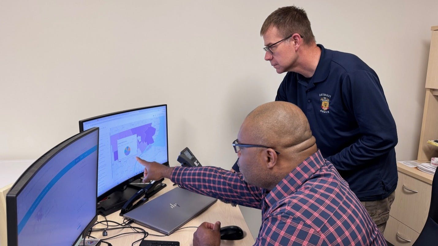 Detroit Fire Department personnel examining interactive maps on screen to fine-tune fire prevention efforts
