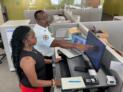 Detroit Fire Department personnel reviewing fire history data on screen to fine-tune fire prevention effotts