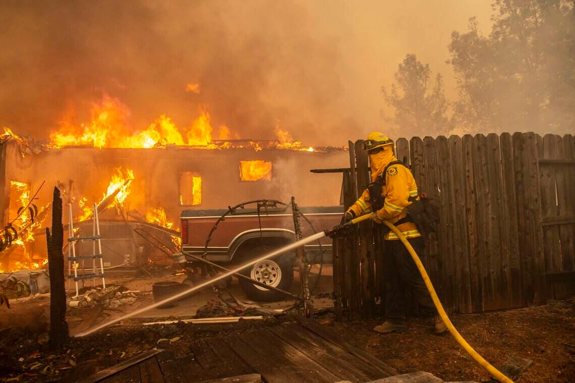 A firefighter operates at the Camp Fire in 2018.