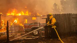 A firefighter operates at the Camp Fire in 2018.
