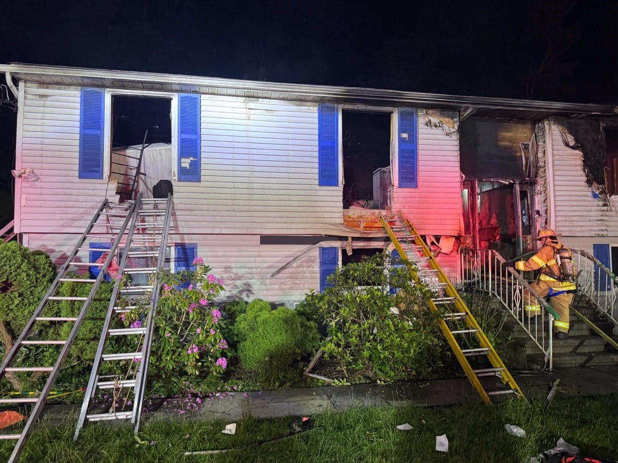 ground ladders positioned at windows of house where victims were rescue during fire