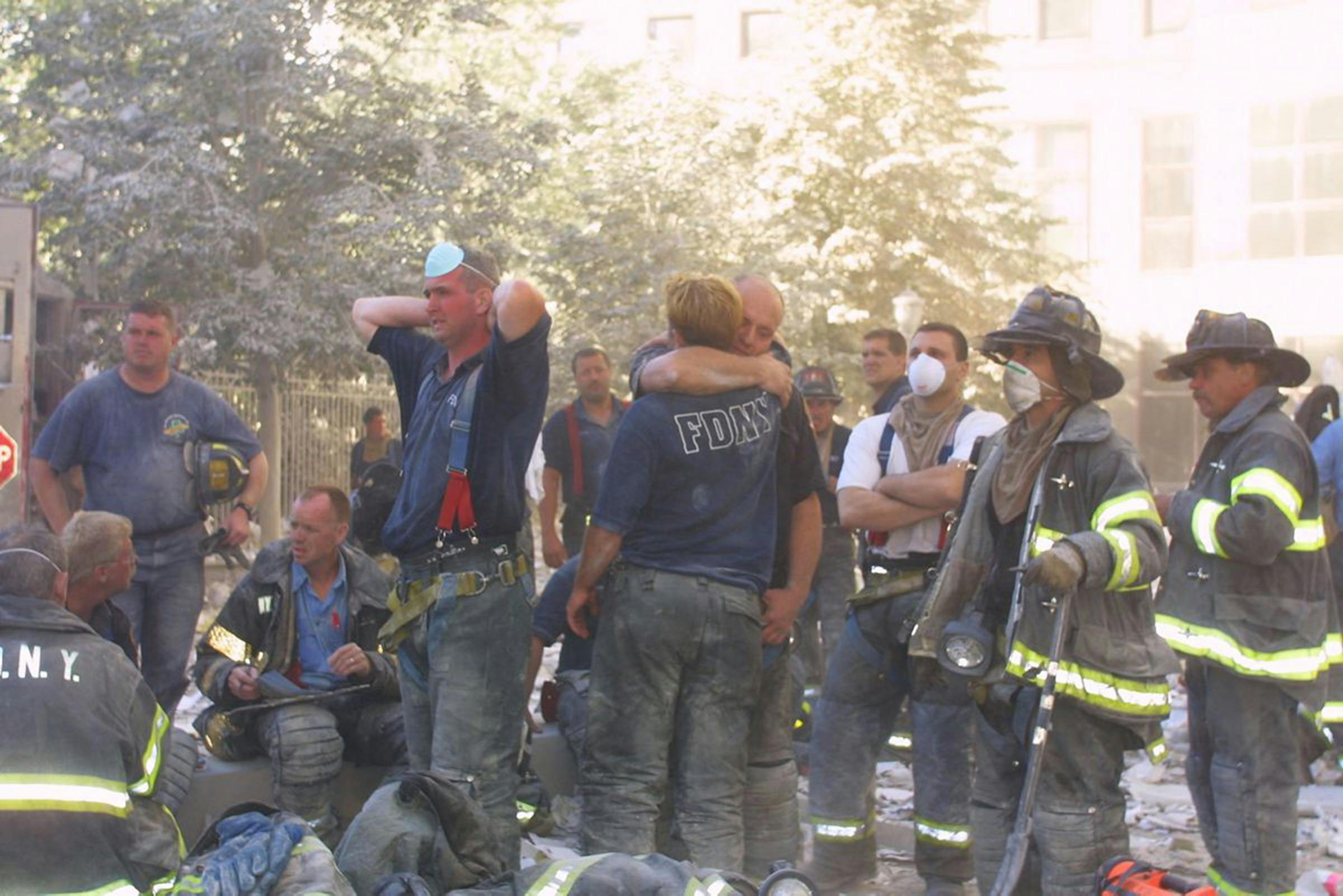 FDNY firefighters console one another at the World Trade Center site on Sept. 11, 2001.