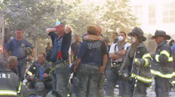 FDNY firefighters console one another at the World Trade Center site on Sept. 11, 2001.
