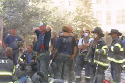 FDNY firefighters console one another at the World Trade Center site on Sept. 11, 2001.