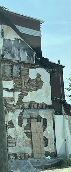 exterior of building that shows void areas between wall studs
