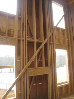 interior of house that's under construction that shows a vertical void space where a fireplace will be located