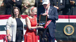President Donald Trump presented the Presidential Medal of Freedom to Allison Crother, the mother of volunteer firefighter, also known as the 'man in the red bandana' Welles Crother, who died after saving 18 stranger in the World Trade Center on Sept. 11. His sister, Paige, is at left.