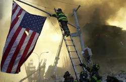 FDNY Capt. Mike Dugan places a flag at the ruins of the World Trade Center.