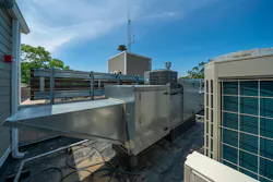 Condensing units for a variable refrigerant flow system as well as a make-up air unit for a kitchen exhaust hood are co-located in a mechanical roof area.