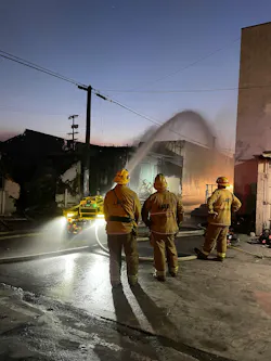 Los Angeles City Fire Department incident commander observing firefighting robot in action