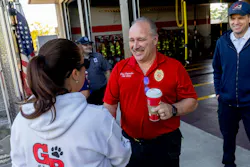 Grand Blanc Fire Chief Don Schreiber II thanks a student for the gift bags she and her classmates delivered to the firehouse.