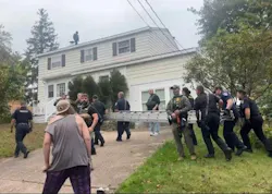 Oswego firefighters and police officers carried a ladder at the request of the U.S. Customs and Border Patrol after two men scurried to the roof during a recent encounter.