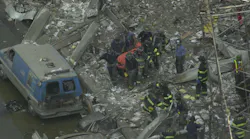 Firefighters carry a body from the rubble of the World Trade Center.