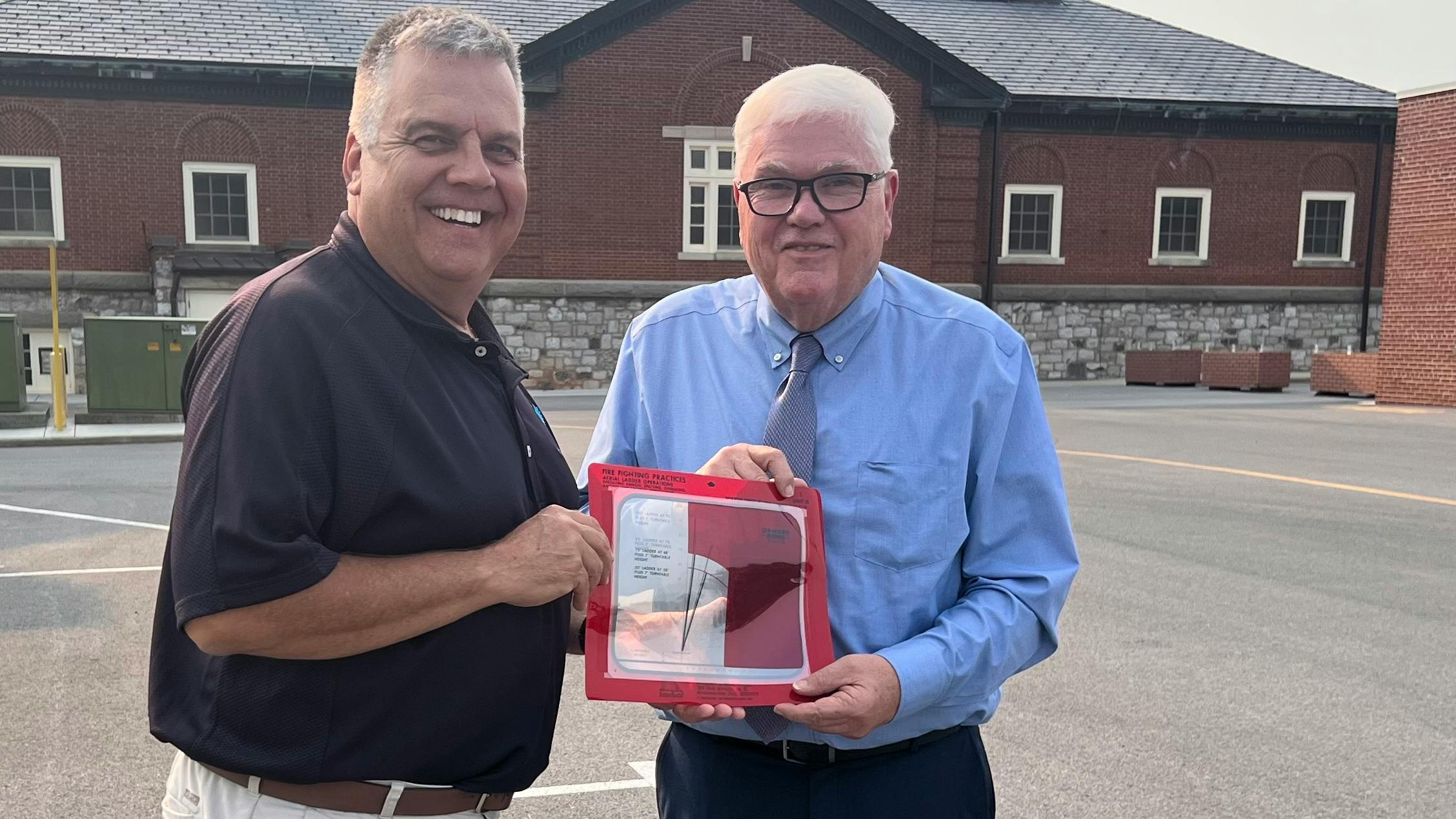 Author Mark Brady (right) donates the 'Brady Firefighting Series' to National Fire Academy Superintendent Eriks Gabliks.