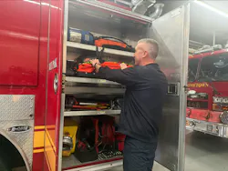 Fire Chief Daniel Duffy of Hometown Fire Protection District shows equipment inside fire truck.
