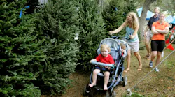 A family searches the Firefighters Christmas Tree lot that's been in operation for 30 years.